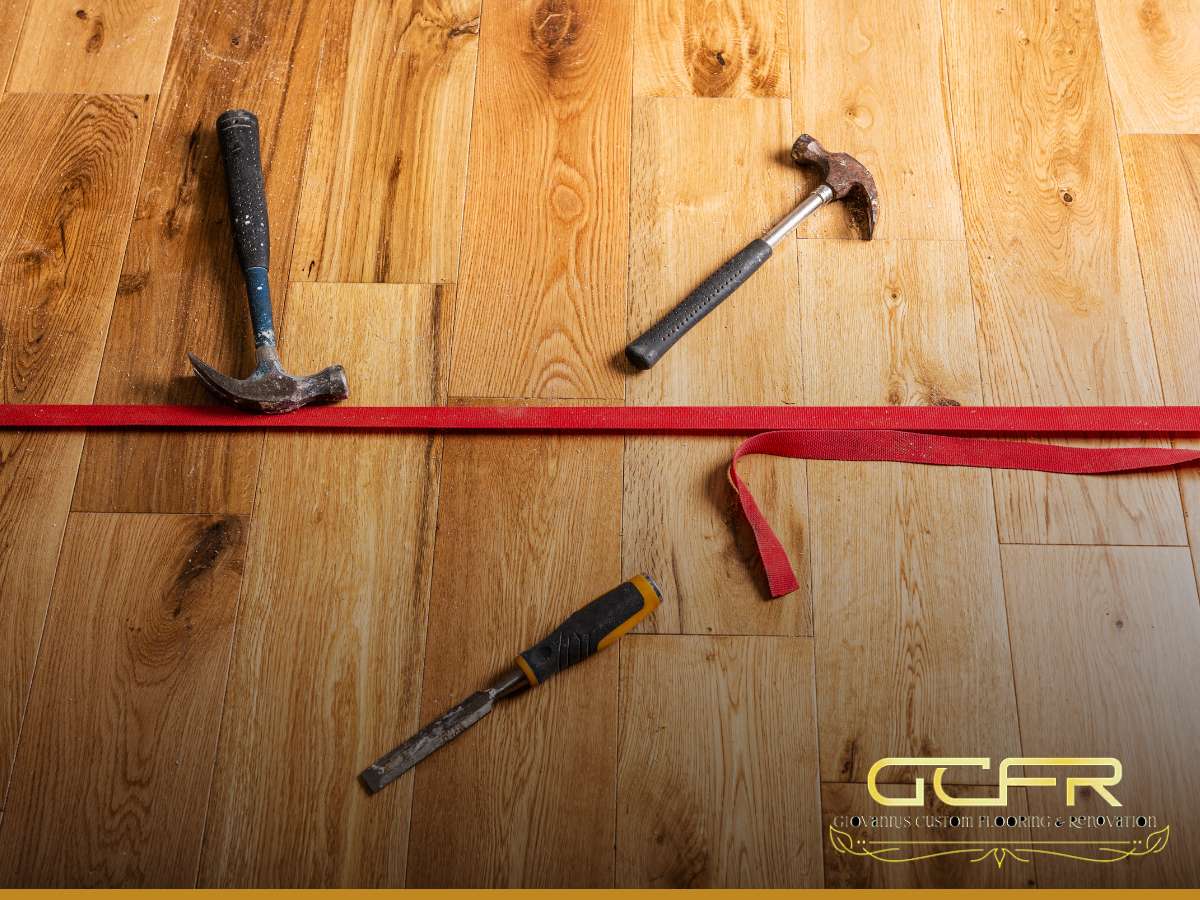 Tools laid out on a new hardwood flooring installation by Giovanni's Custom Flooring & Renovation